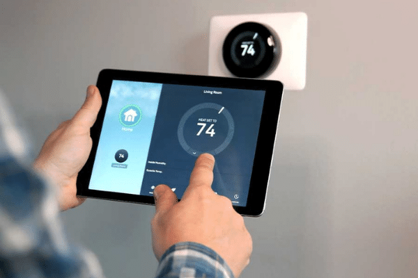 Person using a tablet to work their smart thermostat
